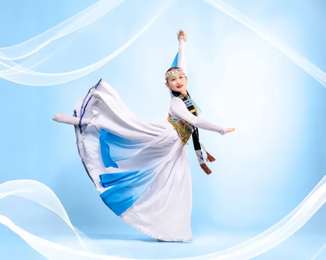Mongolian dancer in a flowing blue and white dress