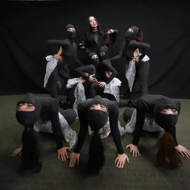 Contemporary dance ensemble in black costumes