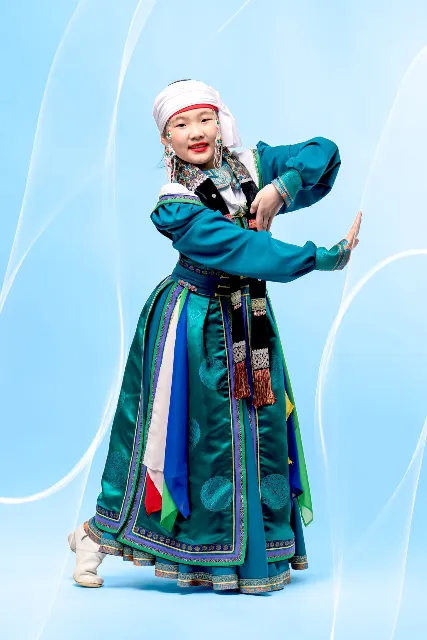 Young dancer in a teal traditional costume