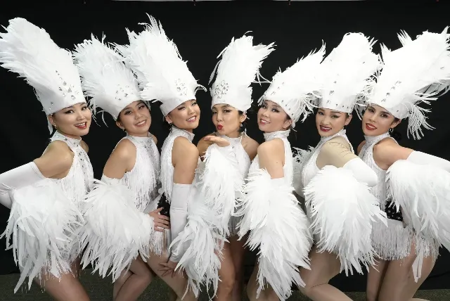 MGL Precious show dance ensemble in feathered costumes